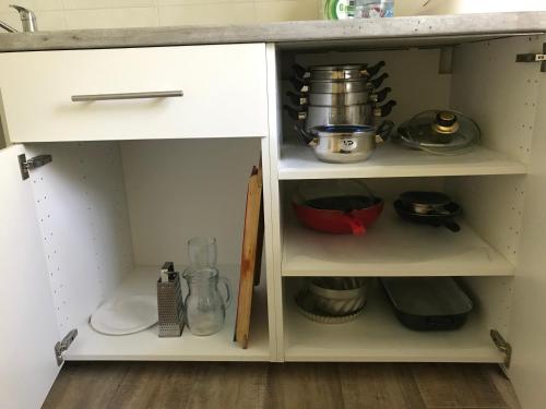 a kitchen cabinet filled with lots of kitchen utensils at Ubytování u Nováků in Malá Morávka