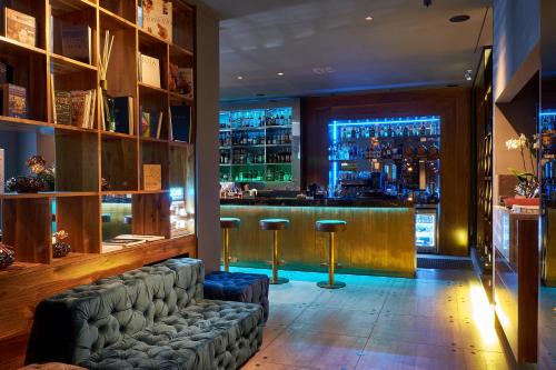 a bar with a couch in front of a bar at Il Decameron Luxury Design Hotel in Odesa