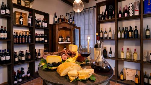 a table with a plate of food and glasses of wine at Abbazia Collemedio Resort & Spa in Collazzone