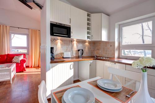 a kitchen with a table with two plates on it at Knaus Camping- und Ferienhauspark Rügen in Altenkirchen