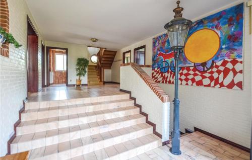 a staircase in a house with a painting on the wall at Lovely Home In Fur With Kitchen in Fur