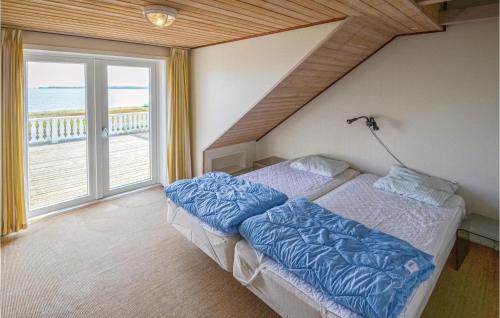 a bedroom with two beds and a large window at Lovely Home In Fur With Kitchen in Fur