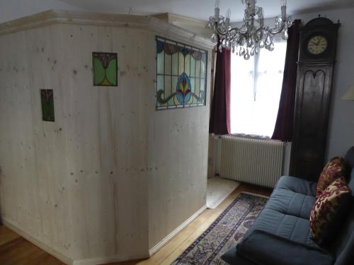 a living room with a wooden wall with stained glass at Pension Zur Rose in Weil am Rhein