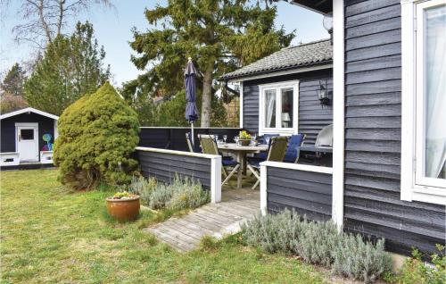 a backyard with a table and a house at Gorgeous Home In Skivarp With Sauna in Skivarp