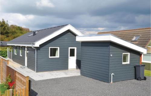 a blue shed with a white door in a driveway at Awesome Home In Esbjerg V With Wifi in Esbjerg