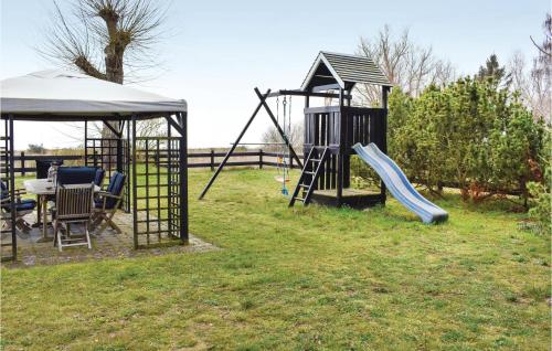 a playground with a slide and a swing set at Gorgeous Home In Skivarp With Sauna in Skivarp
