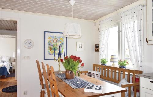 a kitchen and dining room with a table and chairs at Gorgeous Home In Skivarp With Sauna in Skivarp