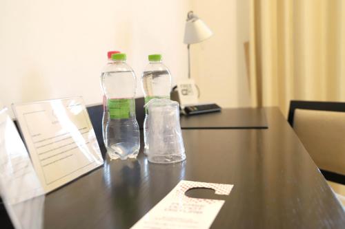 two water bottles sitting on a table in a hotel room at Albergo Cantiani in Ancona