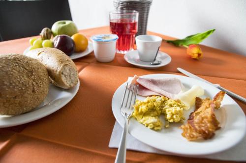 a table with a plate of food with eggs and bread at Albergo Cantiani in Ancona
