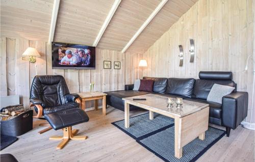 a living room with a couch and a table at Awesome Home In Blåvand With Wifi in Blåvand