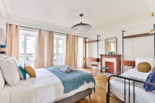 une chambre avec deux lits et une cheminée dans l'établissement 99 - Urban Fabulous 6 Bedrooms, à Paris