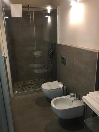 a bathroom with a shower and a toilet and a sink at Residenza Solferino in Cremona