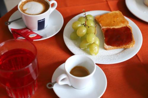 a table with two plates of food and a cup of coffee at Albergo Cantiani in Ancona