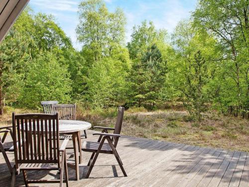 a patio with a table and chairs on a deck at 6 person holiday home in L s in Læsø