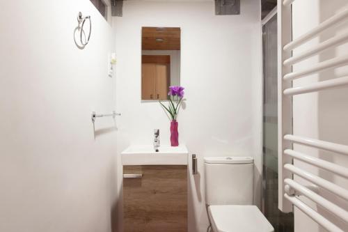 a white bathroom with a sink and a toilet at Gaudí Ramblas in Barcelona