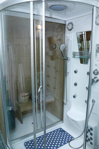 a shower with a glass door in a bathroom at Гостиница Север ТОО Север in Pavlodar