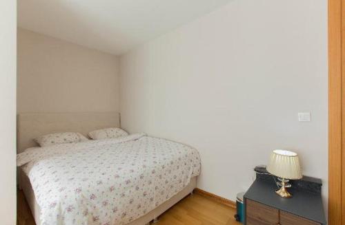 a bedroom with a bed and a table with a lamp at CTS Elysium Residence Taksim in Istanbul