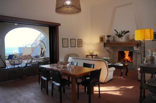 a living room with a table and a fireplace at Villa Mallandrino in Mondello