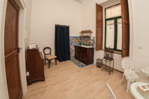 a living room with a sink and a fireplace at Casa Galione in Cava deʼ Tirreni