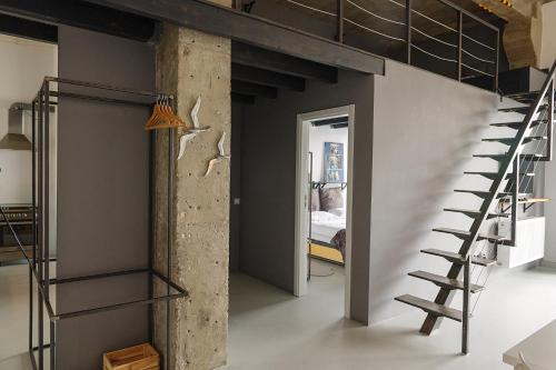 a loft apartment with a staircase and a bedroom at Cluj Apartments in Cluj-Napoca