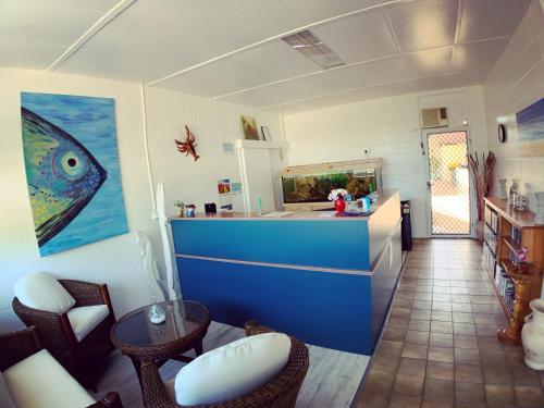 a kitchen with a fish tank on the wall at Tropical City Motor Inn in Ayr