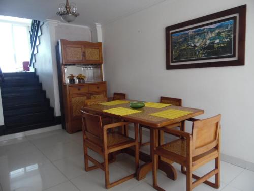 a dining room with a wooden table and chairs at Karey 1506 Rodadero in Gaira