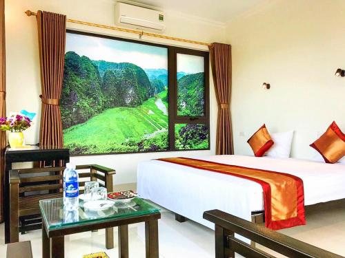 a bedroom with a large window with a mountain view at Trang An Mountain View Homestay in Ninh Binh