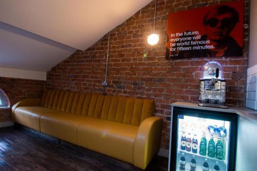 a leather bench in a room with a brick wall at York Street Studios in Liverpool