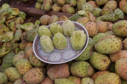 a bowl sitting on top of a pile of fruit at Dar Rbab in Fès