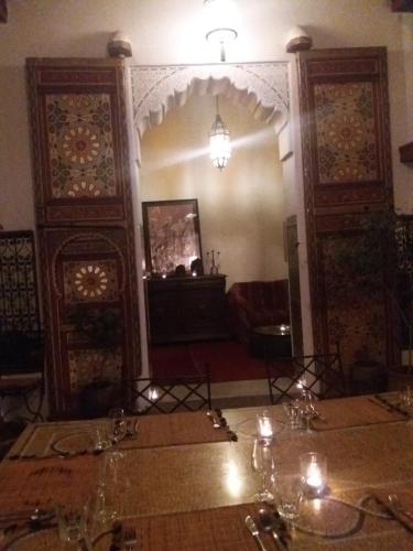a dining room with a table with candles on it at Dar Rbab in Fès