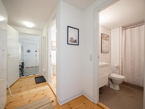 a white bathroom with a toilet and a sink at Renovated 1bedroom apartment in Central Copenhagen in Copenhagen