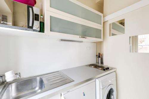 a kitchen with a sink and a washing machine at Unit 015 Notre Dame (Ursins n°2) in Paris