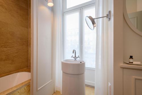 a bathroom with a sink and a window at Bairro Alto Hotel in Lisbon
