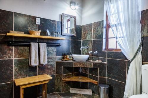 a bathroom with a sink and a mirror at Karoo View Cottages in Prince Albert