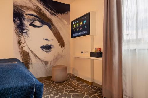 a room with a painting of a woman on the wall at Holiday Inn - the niu, Ridge Halle Central Station by IHG in Halle an der Saale