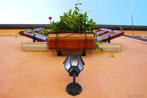 a planter on top of a building with a street light at B&B AL TEATRO ROMANO in Benevento