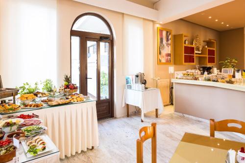 a kitchen with a buffet of food on a table at Eltina Hotel in Rethymno Town