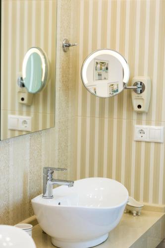 a bathroom with a white sink and a mirror at Contessa Del Mare in Panormos Rethymno