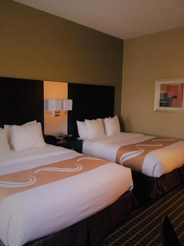 two beds in a hotel room with two at Quality Inn & Suites Windsor - Downtown in Windsor