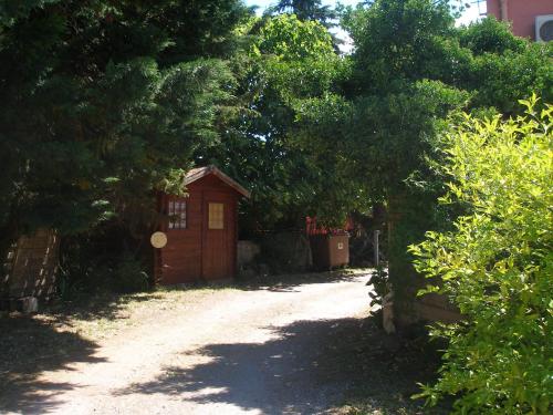 a small house in the middle of a dirt road at La Chaumiere d Agde in Agde