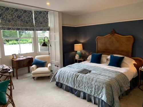 a bedroom with a large bed with blue walls at The Traddock in Austwick