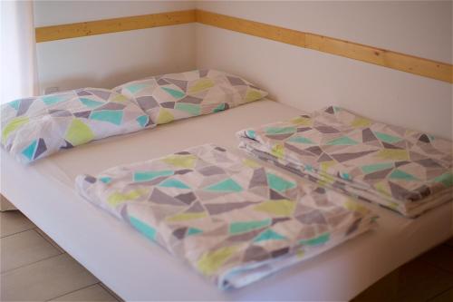 two beds sitting on a shelf in a room at Tourist Farm Apartments Lovrec in Jiršovci