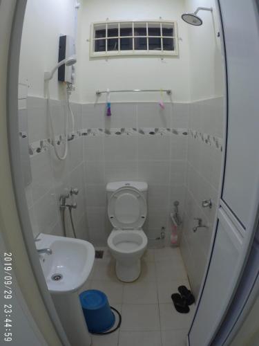 a small bathroom with a toilet and a sink at Holiday Homestay Dungun in Dungun