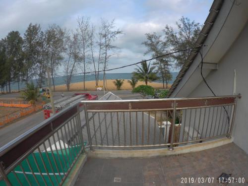 a balcony with a view of a street and the ocean at Holiday Homestay Dungun in Dungun