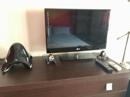 een tv en wat actiefiguren op een ladekast bij Casa Delfino - Appartamento Centro Storico a due passi dalla Spiaggia & Mare, Porto & Ferrovia in Civitavecchia