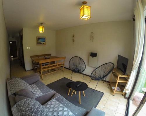 a living room with a couch and a table at Apart Hotel Gran Pacifico in La Serena