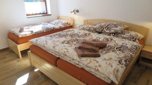 a bedroom with two beds with towels on them at Club Rezidence Pod Lučí in Loučovice