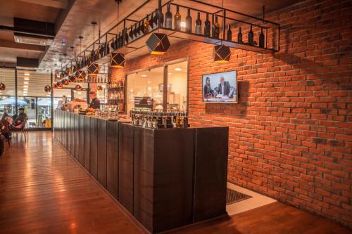 a brick wall with a bar in a restaurant at Qama Hotel in Pristina