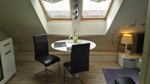a room with a table and two chairs and a window at Pension Villa Marit in Prague