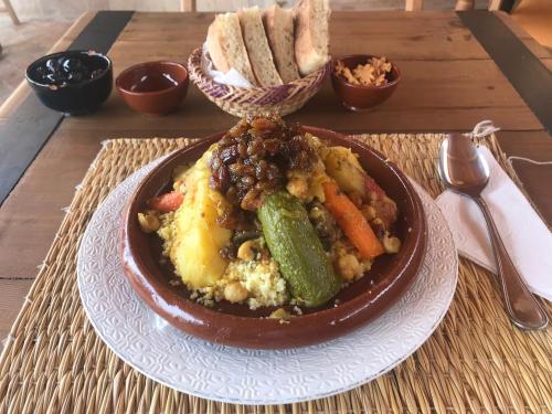 a plate of food with vegetables and bread on a table at Terrace House in Marrakech